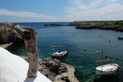 High angle view of sailboats in sea against sky