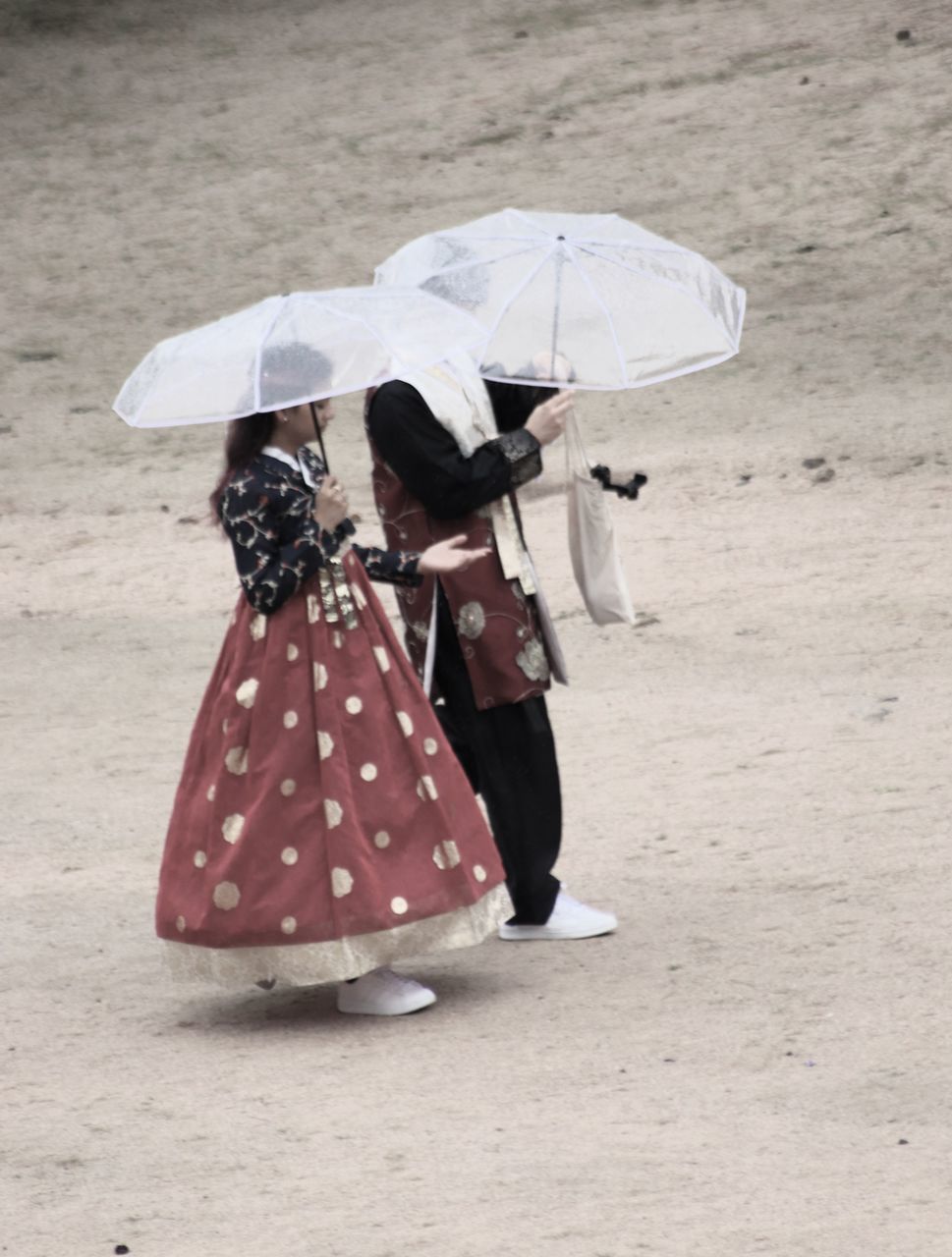 umbrella, protection, adult, women, security, clothing, rain, full length, fashion accessory, nature, land, wet, one person, parasol, holding, day, outdoors, polka dot, walking, female, lifestyles, traditional clothing, leisure activity