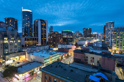 High angle view of illuminated buildings in city at dusk