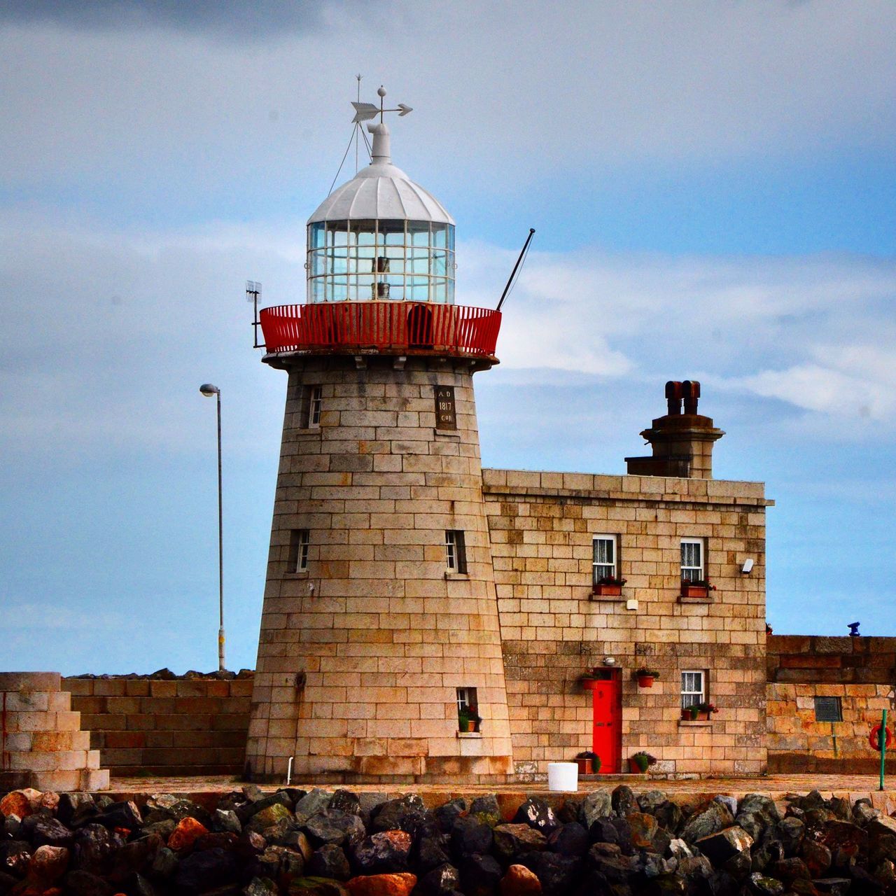 building exterior, architecture, built structure, lighthouse, low angle view, sky, religion, guidance, place of worship, tower, spirituality, direction, cloud - sky, protection, day, safety, cross, outdoors, church