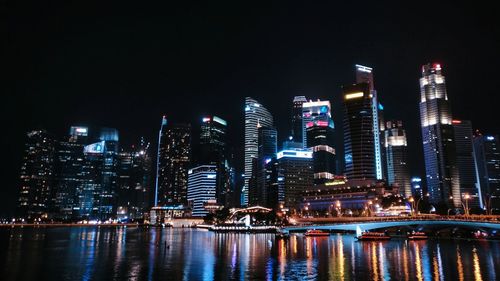 Illuminated buildings against sky at night