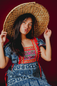 Beautiful young woman in hat looking away