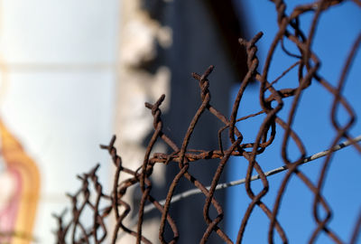 Close-up of chainlink fence against sky