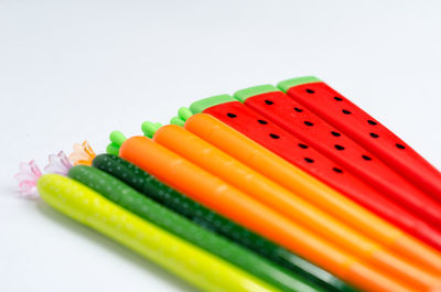 Close-up of colored pencils against white background