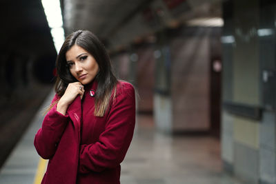 Portrait of young woman standing outdoors