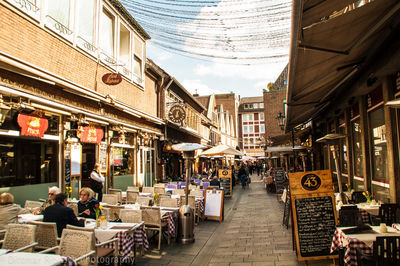 People on sidewalk cafe in city