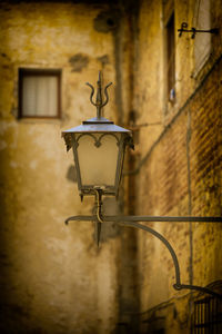 Old lamppost in an alley in montalcino, italy