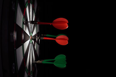 Close-up of illuminated lighting equipment against black background