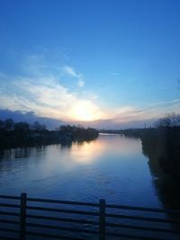 Scenic view of lake against sky at sunset