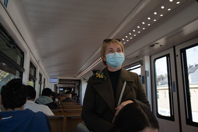 Woman looking out the window of wuppertaler schwebebahn, wuppertal suspension