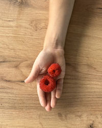 Cropped image of man holding strawberry