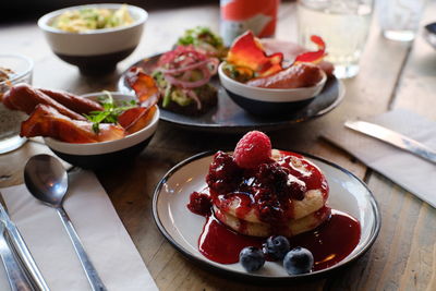 High angle view of brunch in plate on table, pancakes