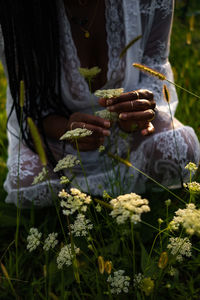 Hand holding flowering plants