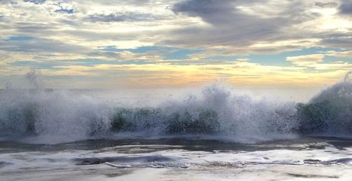 Scenic view of sea against cloudy sky