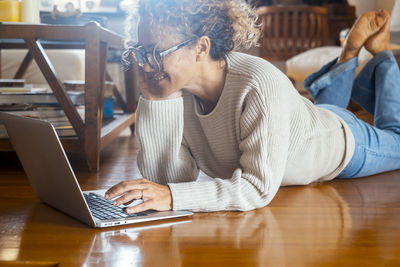 Young woman using laptop at table