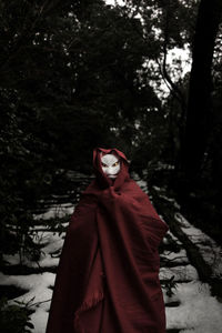 Woman standing in forest