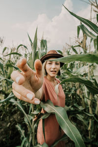 Portrait of smiling woman against plants