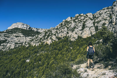 Woman hiking on a mountain path in catalonia on a cloudy summer day