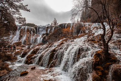 Scenic view of waterfall against rocks