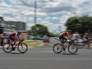 People riding bicycle on road