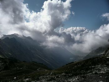 Scenic view of mountains against cloudy sky