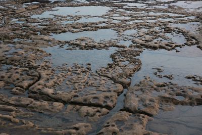 High angle view of wet sand on beach