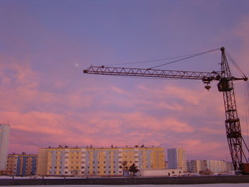 Low angle view of cranes at construction site
