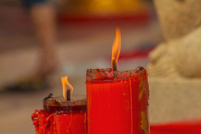 Close-up of lit candles in temple