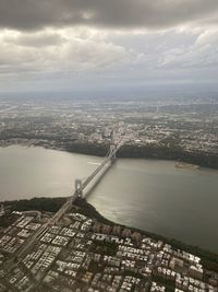 High angle view of river by buildings in city against sky