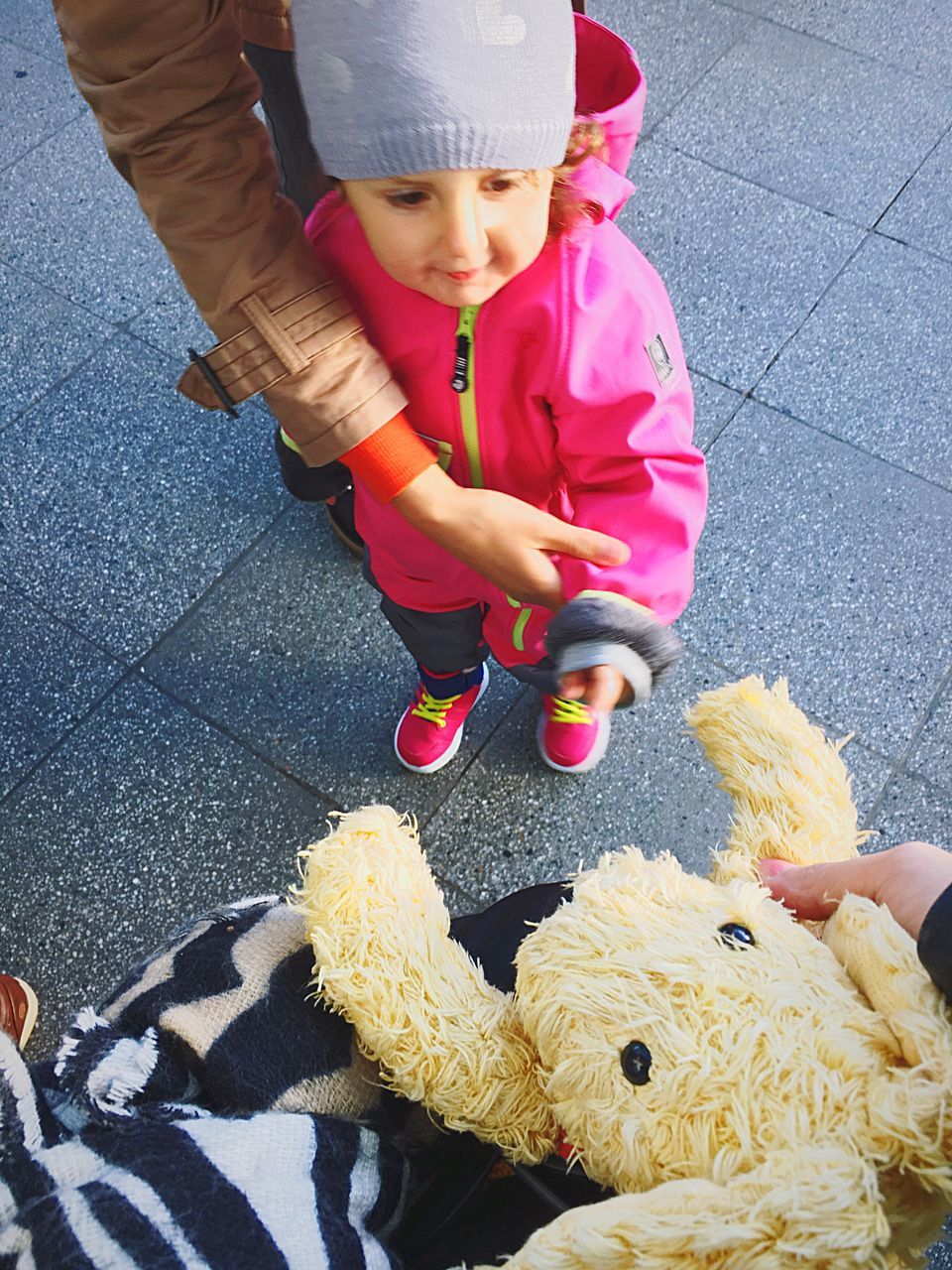 childhood, child, real people, women, toy, girls, females, lifestyles, high angle view, two people, leisure activity, stuffed toy, day, innocence, people, city, cute, full length, footpath, teddy bear