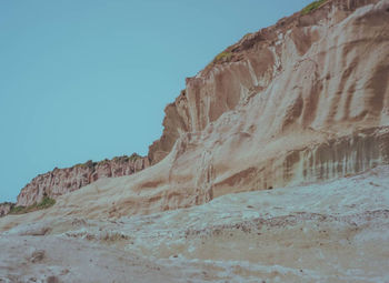 Rock formations against clear blue sky