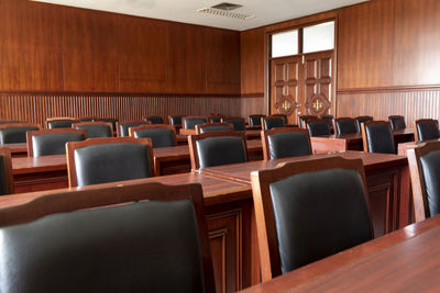 Empty chairs and tables in courtroom