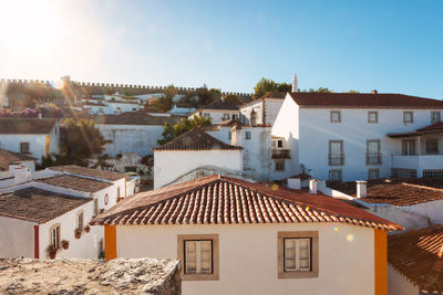 Houses in town against sky