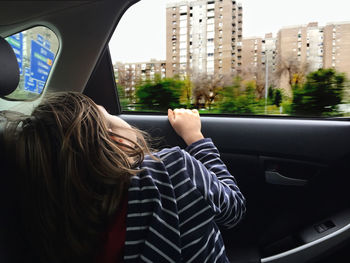 Rear view of girl in car