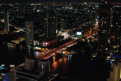 High angle view of illuminated buildings in city at night