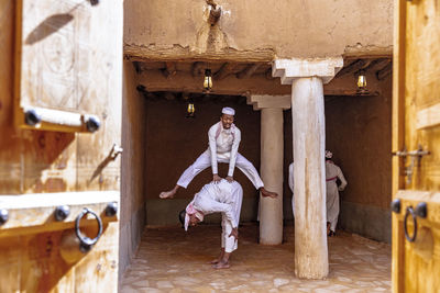 Full length of woman standing against building