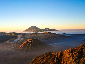 View of volcanic mountain against sky during sunset