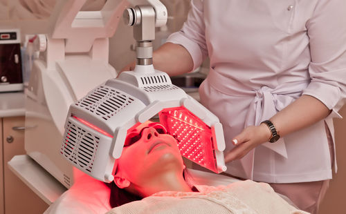 Woman receiving laser treatment on face