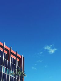 Low angle view of modern building against blue sky