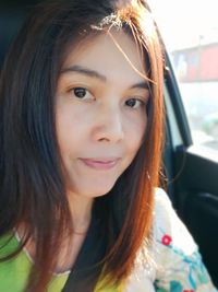 Close-up portrait of smiling young woman