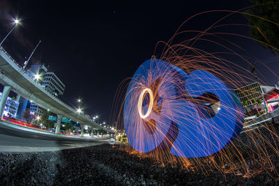 Low angle view of light trails at night