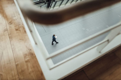 High angle view of man walking in corridor