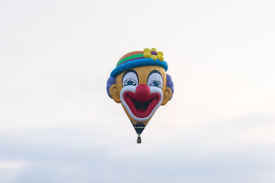 Low angle view of hot air balloon flying against sky