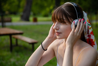 Portrait of young woman exercising in park