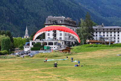 Paragliding on the landing point on a meadow near the centre of the alpine town in summer, chamonix