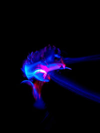Close-up of blue water against black background