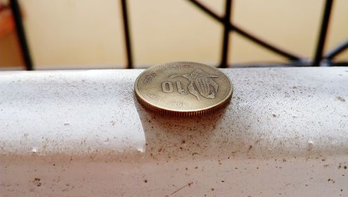 Close-up of coins on table