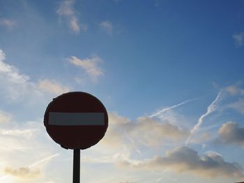 Low angle view of road sign against sky