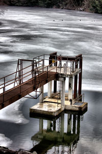 Pier on lake against sky