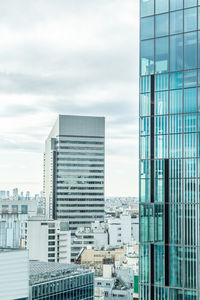 Modern buildings against sky in city